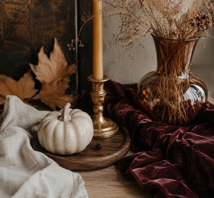Halloween decor materials including velvet, ceramic, wood, linen, and brass accents