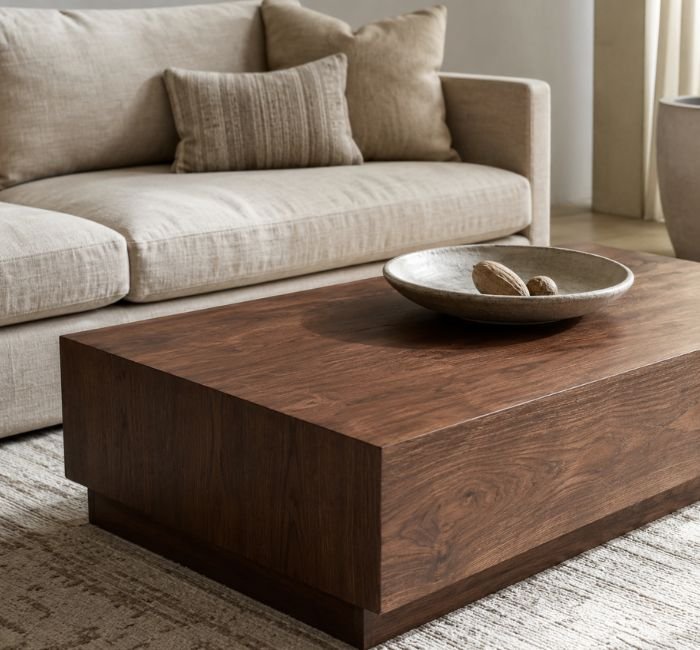 Walnut coffee table decorated with a low handmade stoneware bowl